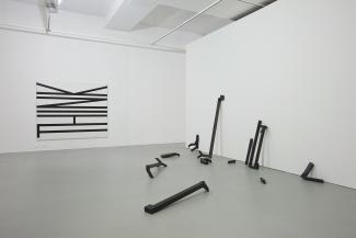 ‘Work for Now’, 2010. Installation view, Australian Experimental Art Foundation, Adelaide, with left: untitled (think), 1990. Enamel panels, each 90 x 210cm; right: the lost routes to lovely, 2001. Oil, gesso, glue, tape, cardboard, dimensions variable.